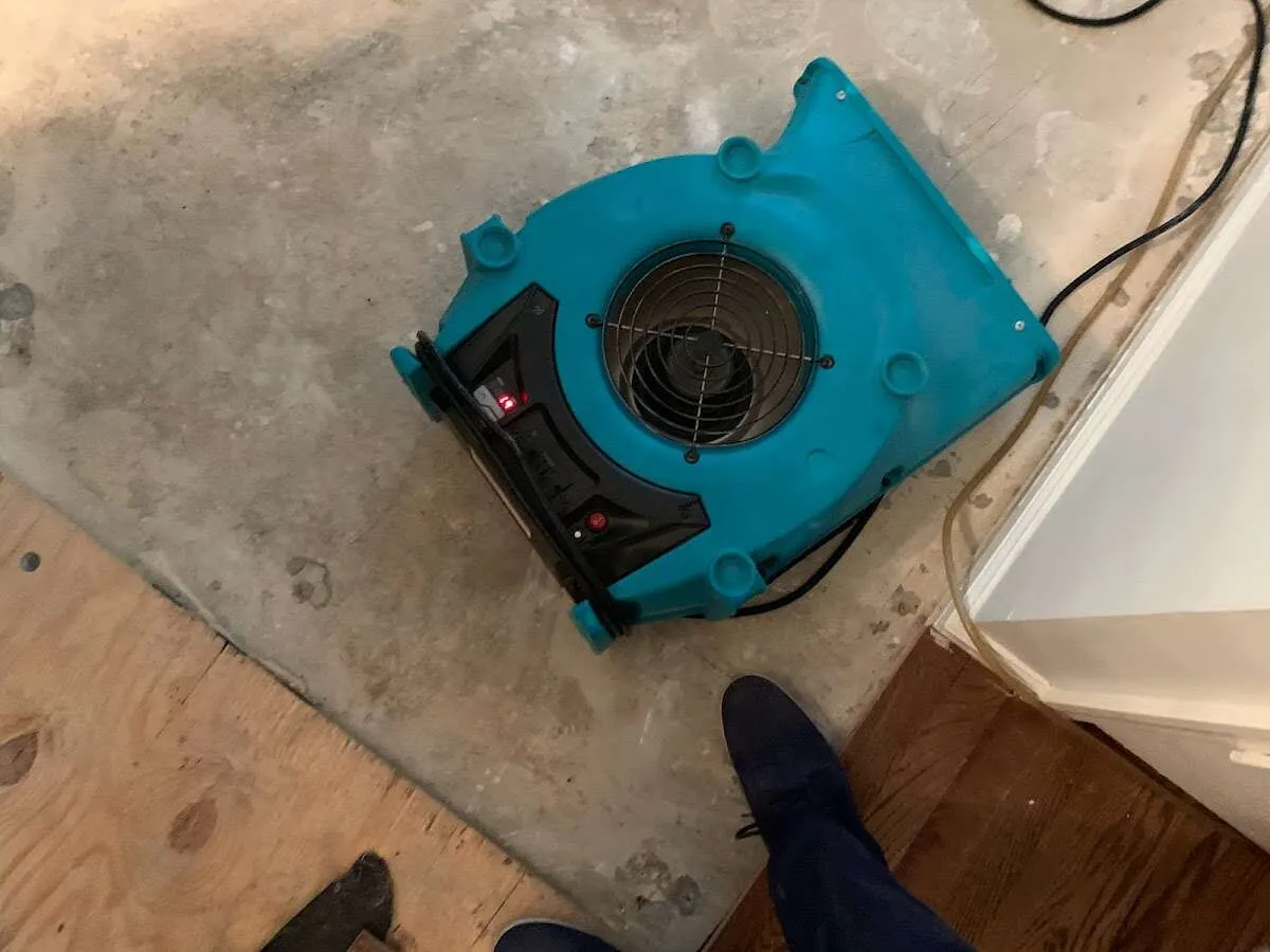 Air mover drying subfloor during Commercial Water Damage Restoration in Cedar Lake